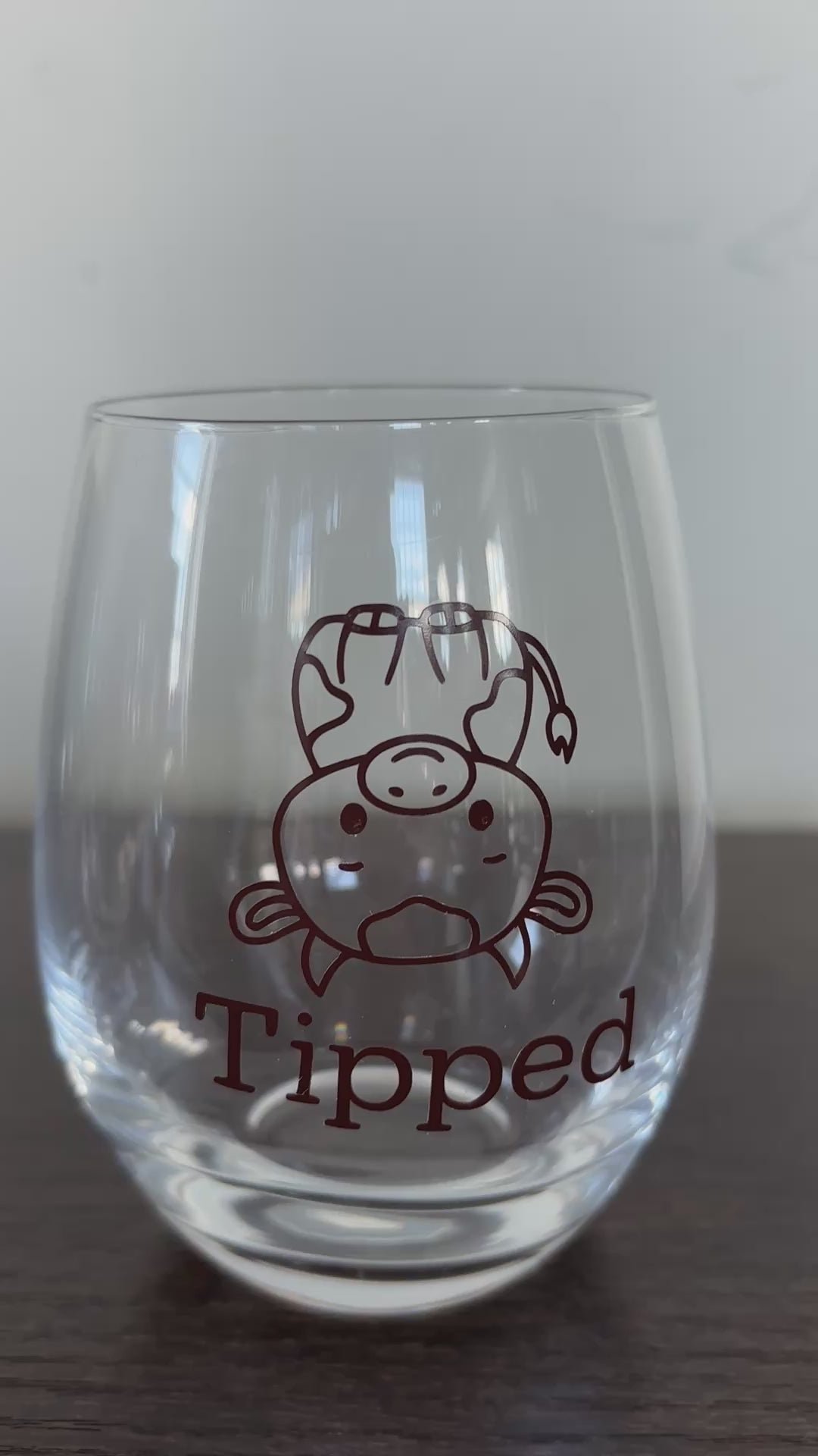 Tipsy or tipped stemless wine glass