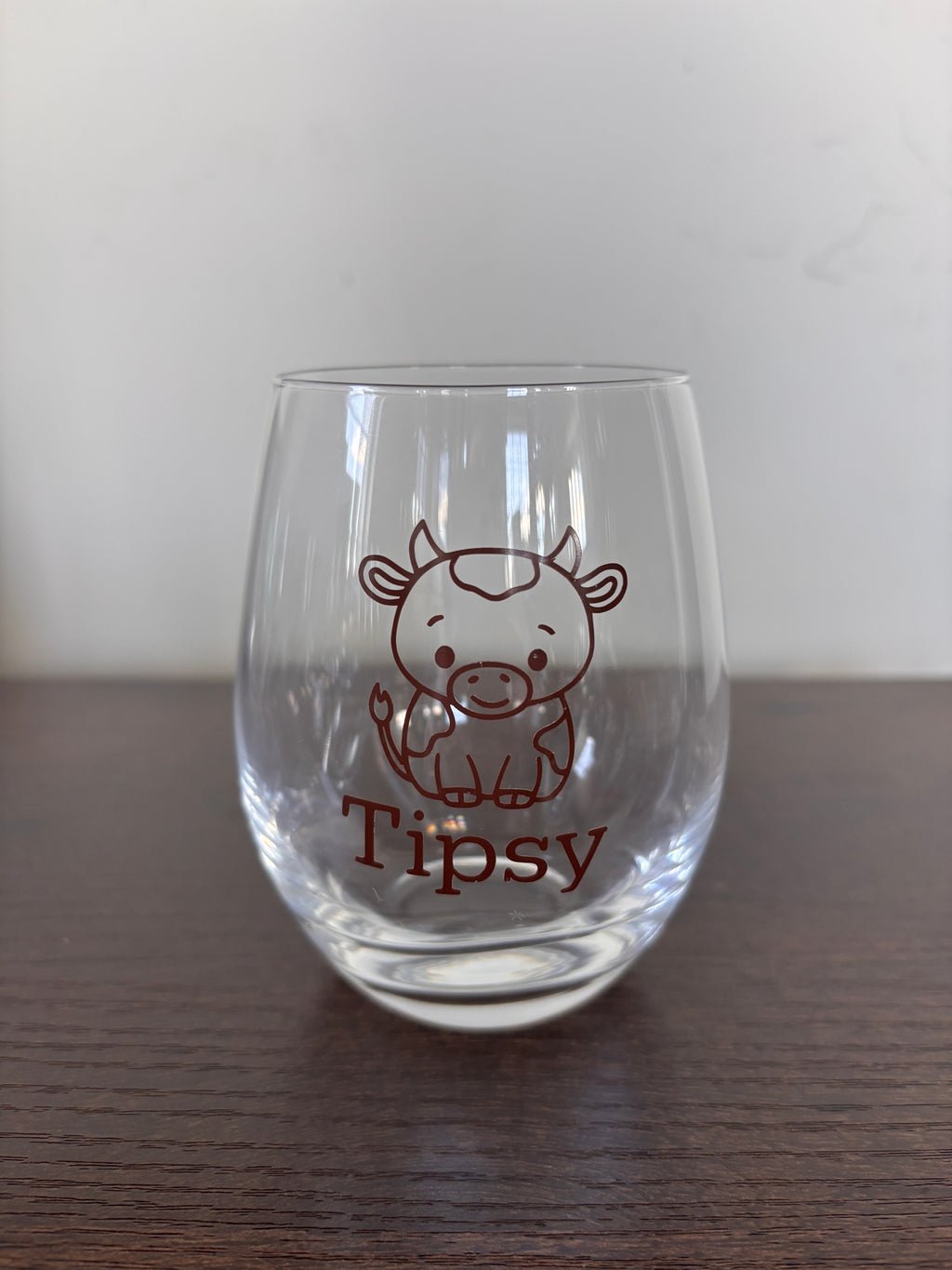 Tipsy or tipped stemless wine glass