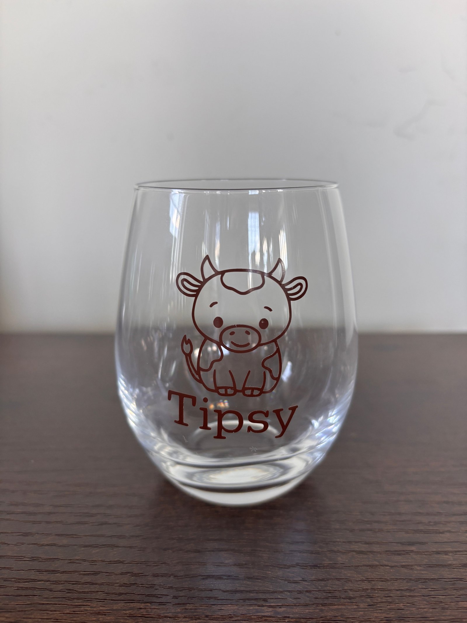 Tipsy or tipped stemless wine glass